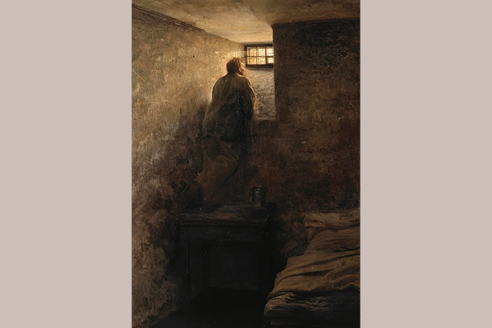 Pintura “El prisionero” de Yaroshenko que muestra a un hombre encarcelado mirando la luz que entra por una ventana.