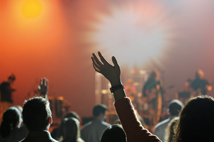 Concierto de rock con jóvenes y luces, símbolo del entorno cultural que interpela a la educación cristiana
